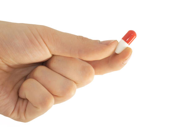 istock tablet capsule is held in the hand with your fingers 1355612633