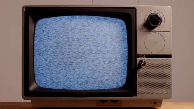 Typical portable TV from the 1970s with interference on screen.colour.