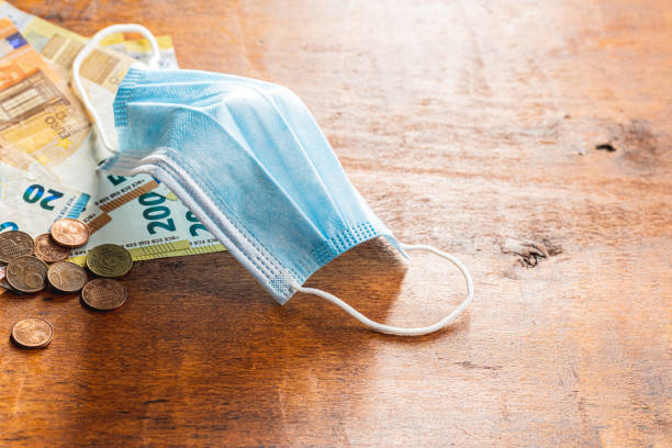 istock Protective face mask and euro banknotes. Coronavirus protection. 1355613723