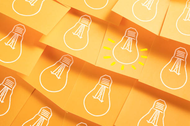 Light Bulbs Drawn on Colorful Sticky Notes stock photo