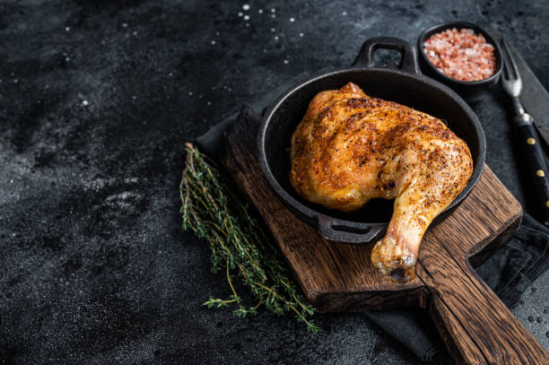 istock Fried bbq chicken leg in a pan. Black background. Top view. Copy space 1355615288