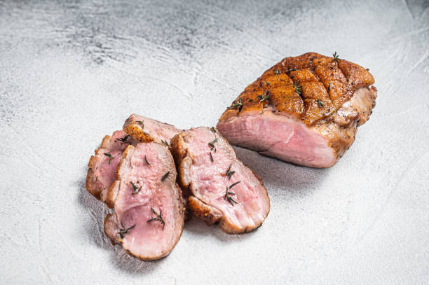 istock Roasted Sliced Duck breast fiilet steak. White background. Top view 1355616342