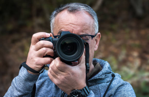 istock Photographer taking photos 1355618260