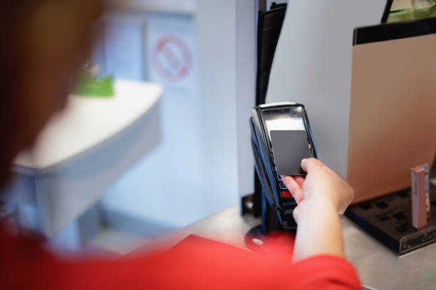 istock Placing credit card on the reader at checkout 1355618807