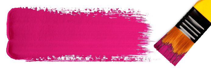 Close-up of a paintbrush with a pink paint stroke (gouache). Isolated on a white background. Space for copy.