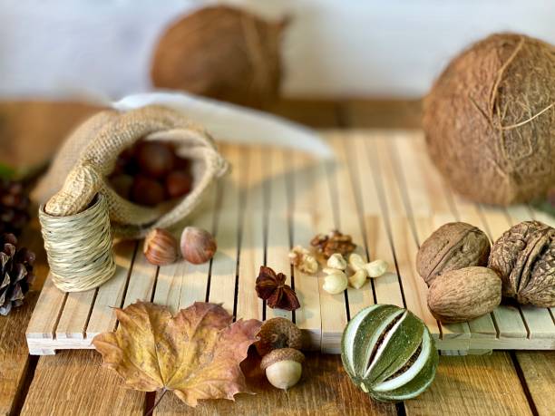 On the oak table are coconut, walnuts and hazelnuts