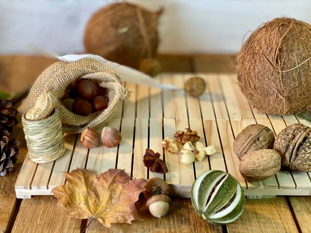 On the oak table are coconut, walnuts and hazelnuts