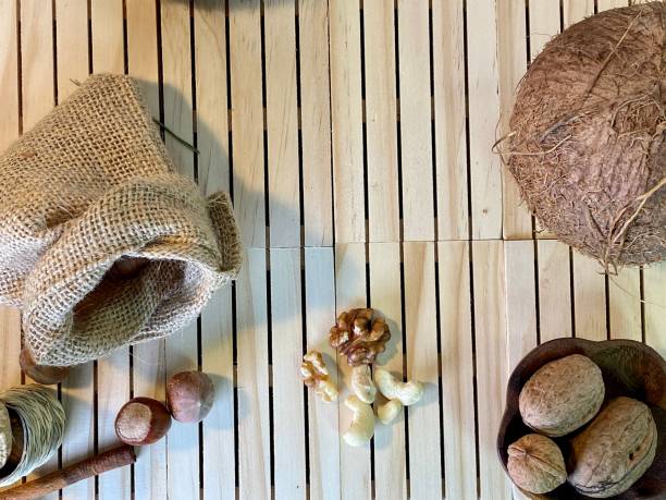On the oak table are coconut, walnuts and hazelnuts