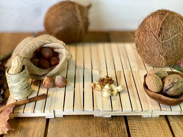 On the oak table are coconut, walnuts and hazelnuts