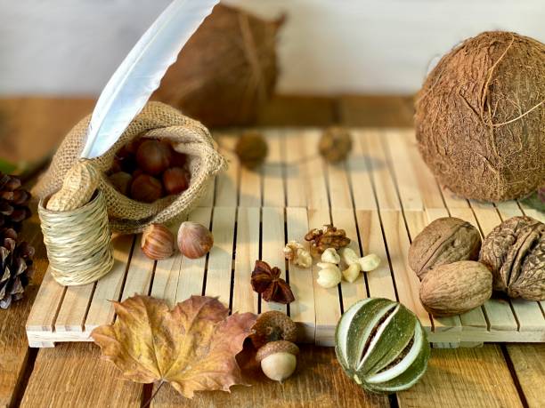 On the oak table are coconut, walnuts and hazelnuts