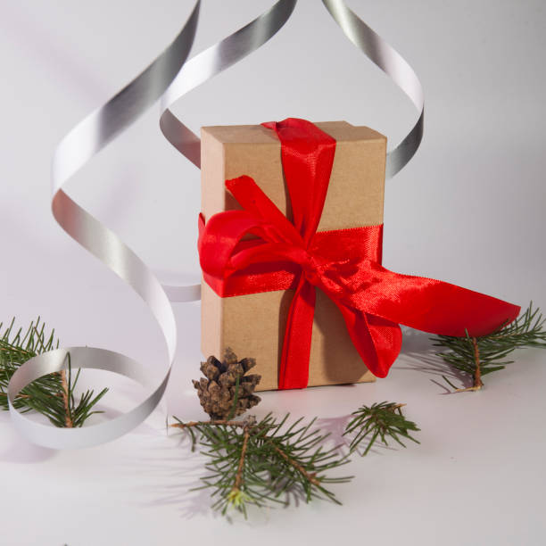 istock Christmas gift in paper box with red ribbon 1355624110