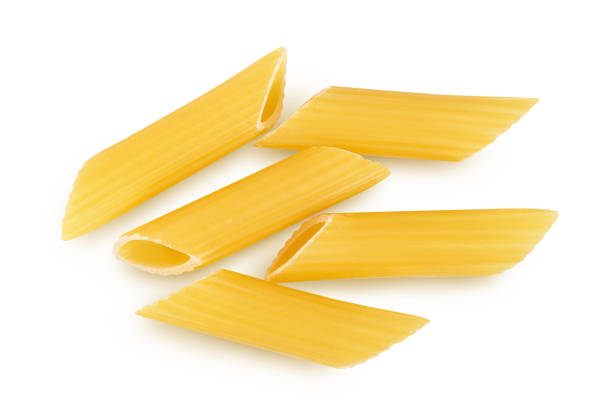 istock Raw italian penne rigate pasta isolated on white background with clipping path and full depth of field. Top view. Flat lay 1355624159
