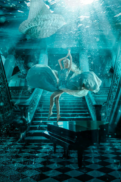 Beautiful woman underwater with piano