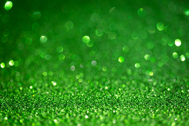 istock Dark green shiny glitter texture. Selective focus. Glowing surface, sparkle lights and bokeh effects. Christmas and festive background 1355626847