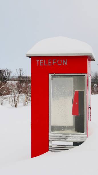 Model of a phone booth in the snow at sunset.