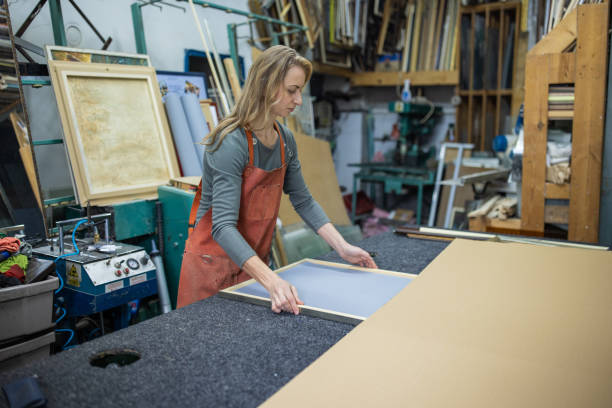 istock At the glass workshop, female employee making the picture frame 1355629392