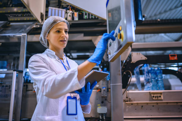 istock Female engineer working on maintenance in bottling plant 1355629501