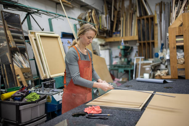 istock At the glass workshop, female employee making the mirror 1355629600