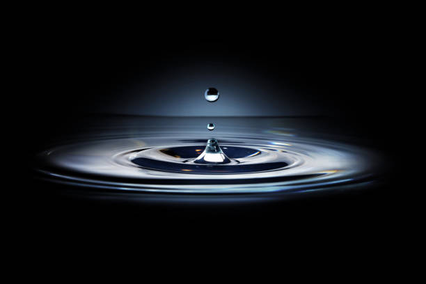 istock Water drops and beautiful waves falling on the calm water 1355630175