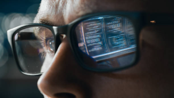 istock Close-up Portrait of Software Engineer Working on Computer, Line of Code Reflecting in Glasses. Developer Working on Innovative e-Commerce Application using Big Data Concept 1355632547