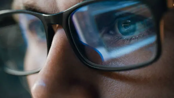 Photo of Close-up Portrait of Software Engineer Working on Computer, Line of Code Reflecting in Glasses. Developer Working on Innovative e-Commerce Application using Machine Learning, AI Algorithm, Big Data