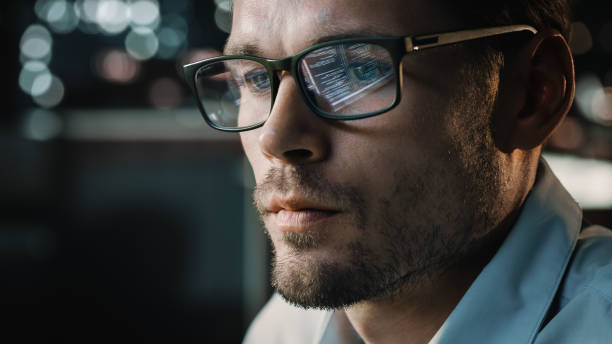 istock Portrait of Handsome Startup Digital Entrepreneur Working on Computer, Line of Code Reflecting in Glasses. Developer Working on Innovative e-Commerce Application using AI Algorithm to use Big Data 1355632556