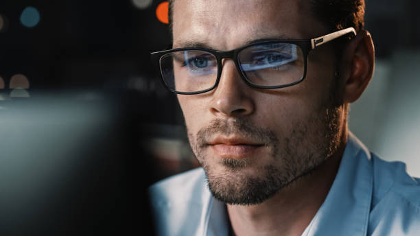 istock Portrait of Male Startup Digital Entrepreneur Working on Computer, Line of Code Reflecting in Glasses. Developer Working on Innovative e-Commerce App using AI Algorithm Big Data. 1355632563