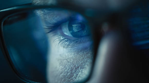 istock Close-up Portrait of Software Engineer Working on Computer, Line of Code Reflecting in Glasses. Developer Working on Innovative e-Commerce Application using Big Data AI. Stylish Macro Shot of Eye 1355632580