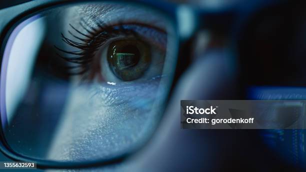 Super Closeup On Female Eye Software Engineer Working On Computer Programming Reflecting In Glasses Developer Working On Innovative Ecommerce Application Using Machine Learning Ai Big Data Stock Photo - Download Image Now