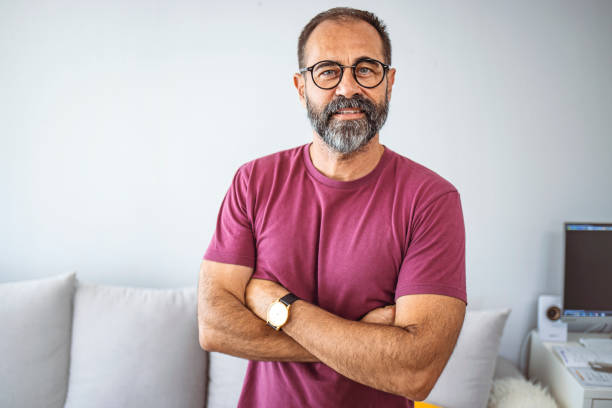 istock Smiling mature man wearing spectacles looking at camera. 1355632708