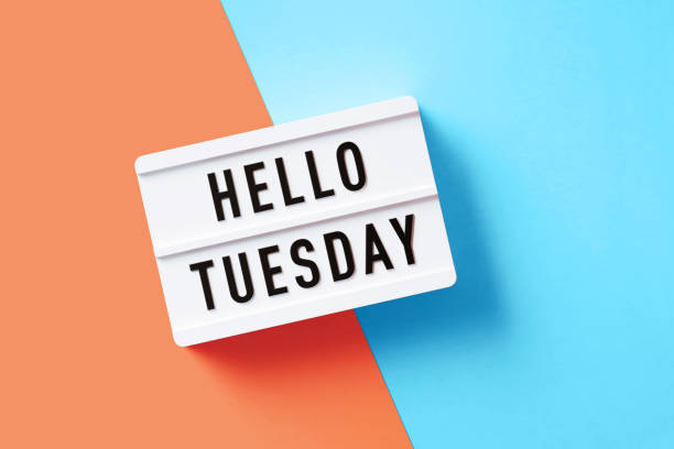 istock Hello Tuesday Written White Lightbox Sitting On Pink And Blue Background 1355635429