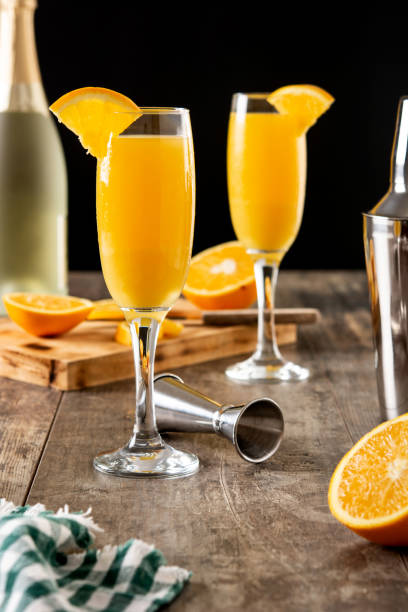 Orange mimosa cocktail Orange mimosa cocktail on wooden table mimosa stock pictures, royalty-free photos & images