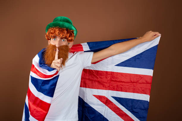 istock St.Patrick 's Day. Funny guy with a red beard on a brown background. 1355637421