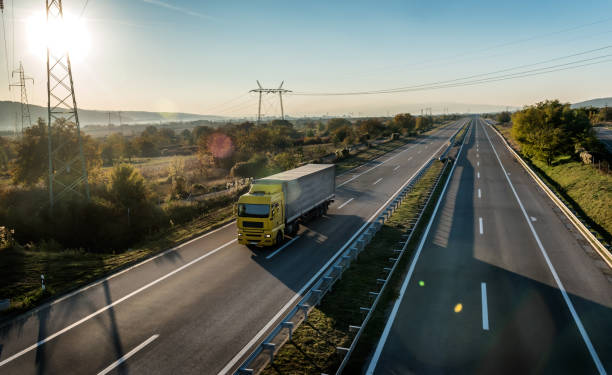 istock Yellow Truck on a countryside highway 1355638649