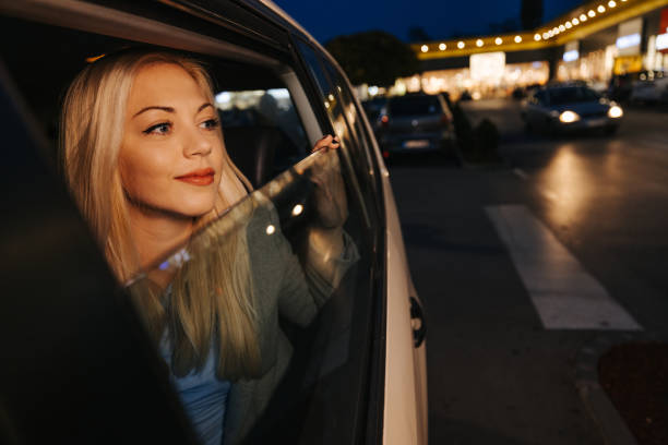 istock Beautiful young woman enjoying night ride 1355643721