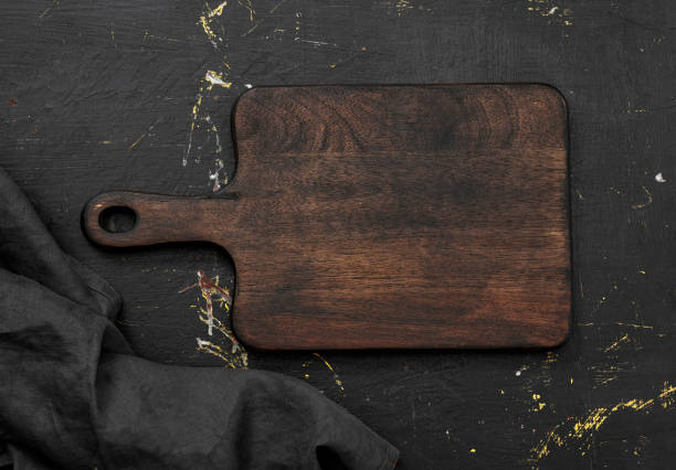 istock Top view of empty cutting board on a wood table 1355643742
