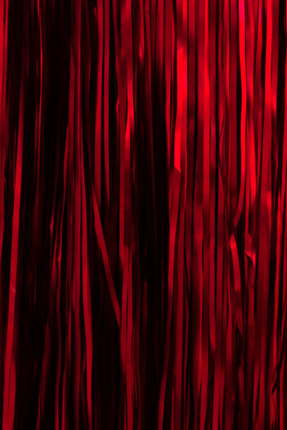 istock Red ribbons hanging Christmas background. 1355643874