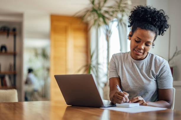 istock Adult african-american woman, using a notepad. 1355647407
