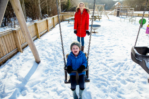 istock Winter Fun on the Swings! 1355648639