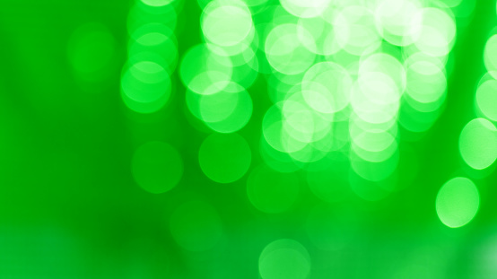 Defocused Christmas green lights background.