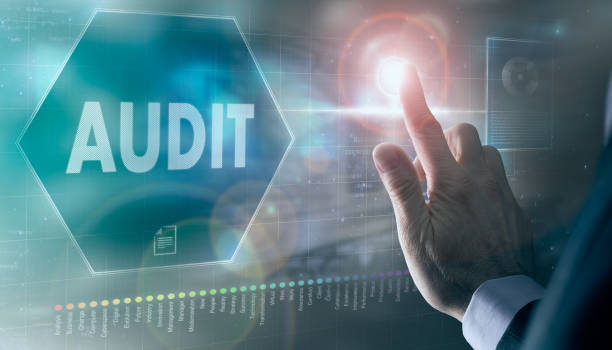 istock A businessman controlling a futuristic display with a Audit concept on it. 1355652213