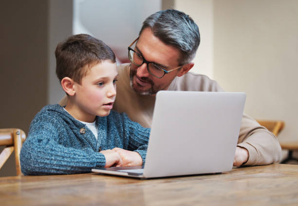 istock Shot of a father and son team using a laptop to complete school work 1355653094