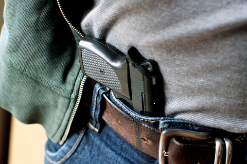 Tucked in a belt pistol being concealed