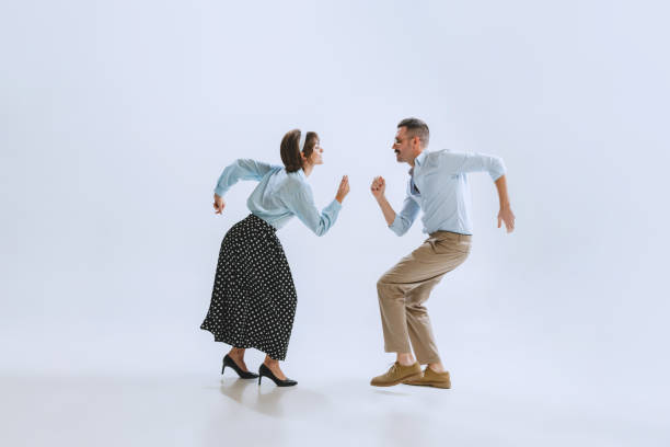 two dancers, young man and woman in old-school fashioned attire dancing rock-and-roll isolated on white background - retro revival couple men elegance imagens e fotografias de stock