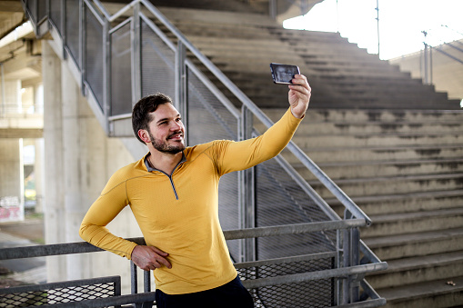 Young man taking a break with a selfie. About 30 years old, Caucasian male.