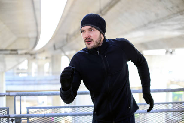 istock Young man running in warm clothing 1355655927