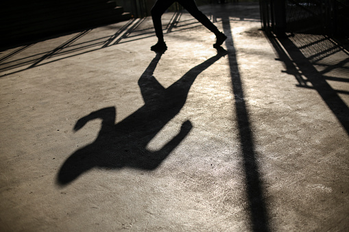Shadow of an unrecognizable young man running.