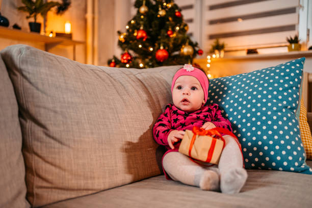istock Baby girl playing with Christmas gift 1355656230
