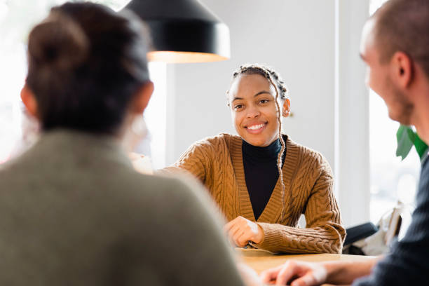 Confident female applicant smiling at job interview stock photo