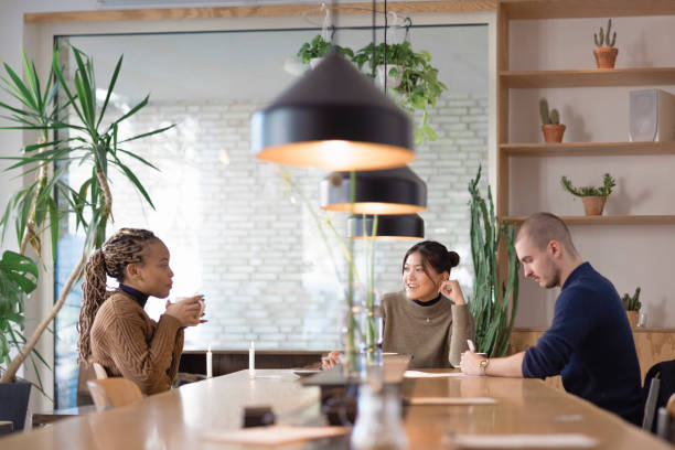 istock Human resources team questioning female candidate sitting in boardroom 1355656424